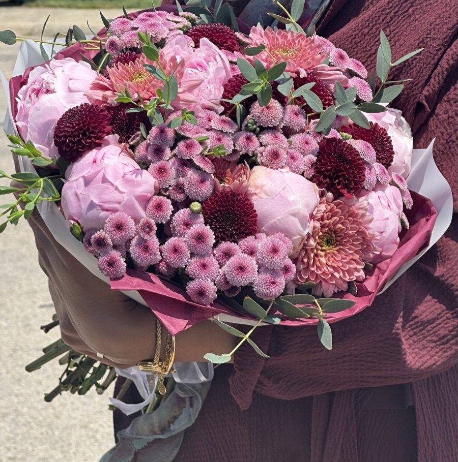 Wrapped bouquet of pink peonies, burgundy santini mums, and seeded eucalyptus